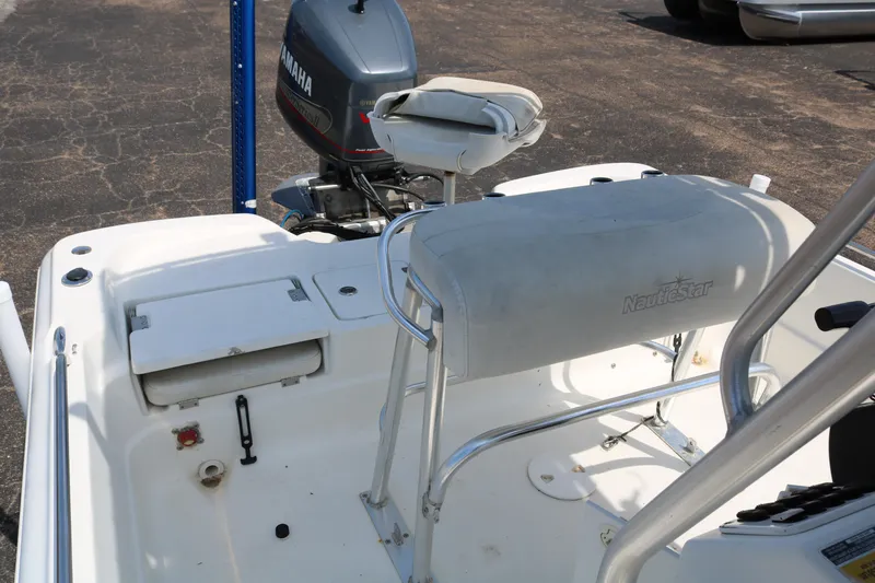 Slide: The Image of 2005 NauticStar 2200 Nautic Bay boat interior with Yamaha engine, featuring seating and storage. - 23