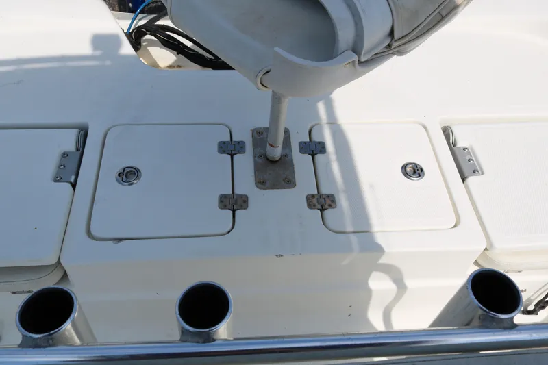 Slide: The Image of 2005 NauticStar 2200 Nautic Bay boat deck with storage compartments and rod holders. - 29