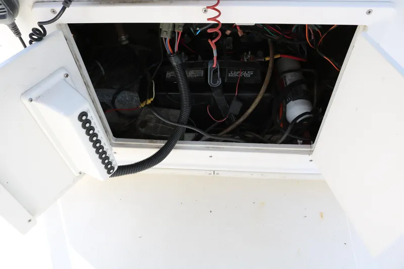 Slide: The Image of Open compartment of 2005 NauticStar 2200 Nautic Bay showing battery and wiring. - 32