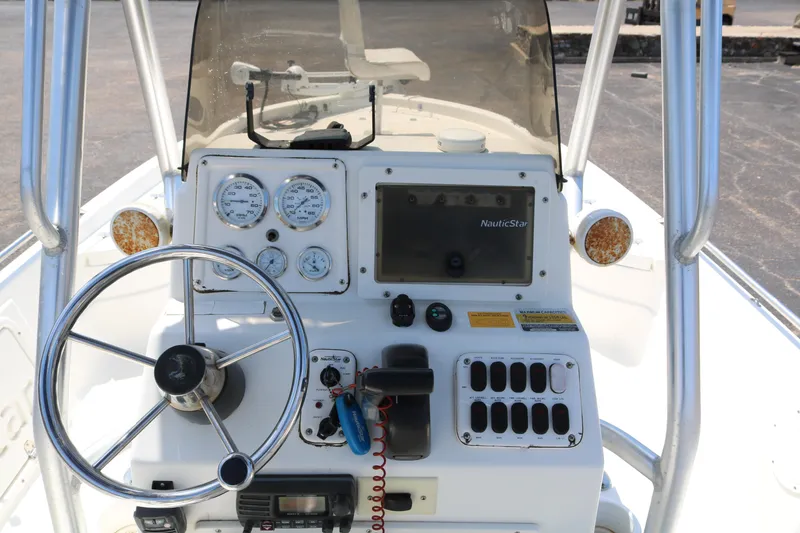 Slide: The Image of 2005 NauticStar 2200 Nautic Bay boat dashboard with steering wheel and gauges. - 33