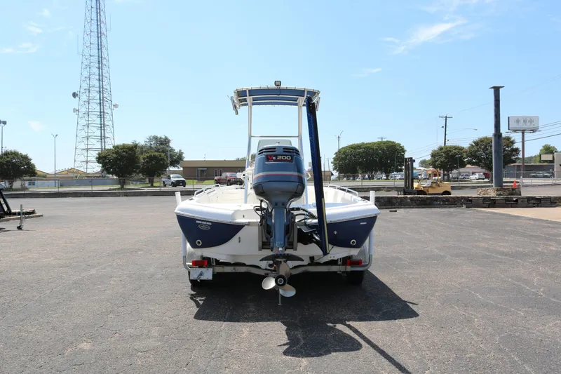 Slide: The Image of 2005 NauticStar 2200 Nautic Bay boat with Yamaha V6 engine, parked outdoors. - 5