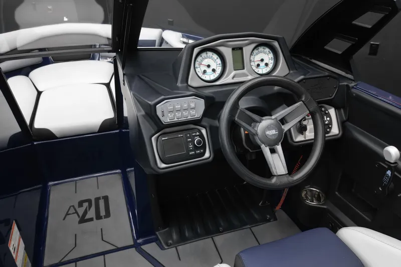 Slide: The Image of 2019 Axis A20 boat cockpit with steering wheel, gauges, and seating. - 10