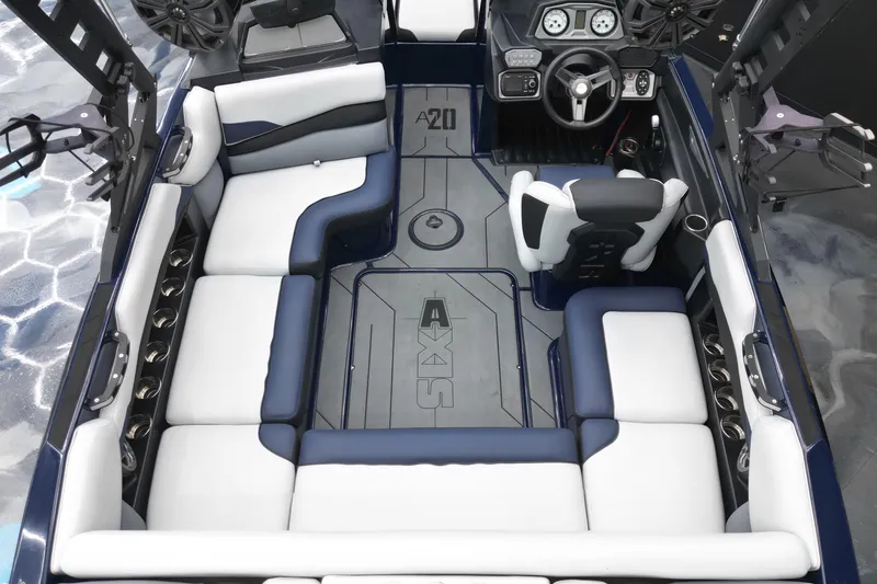 Slide: The Image of 2019 Axis A20 boat interior with white and blue seating, modern dashboard, and spacious layout. - 11