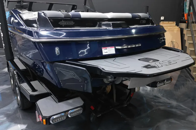 Slide: The Image of 2019 Axis A20 boat, rear view, on trailer in showroom. - 14