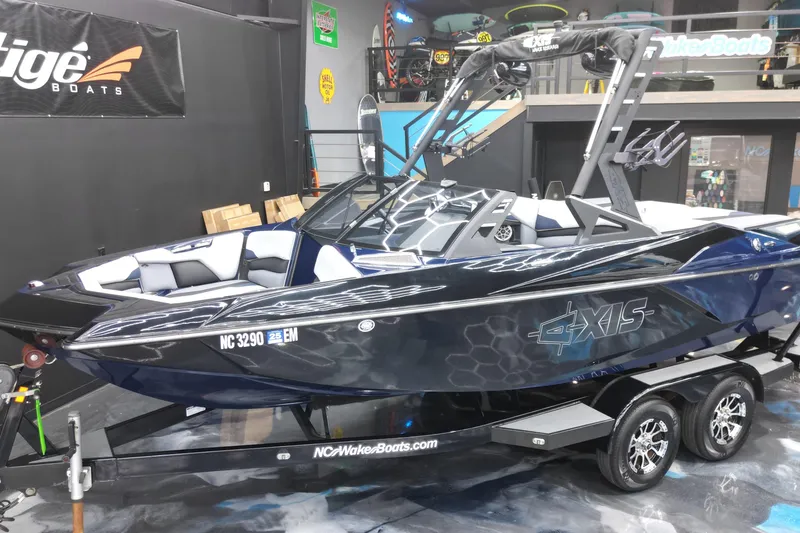 Slide: The Image of 2019 Axis A20 boat on trailer in showroom, featuring sleek design and modern graphics. - 17