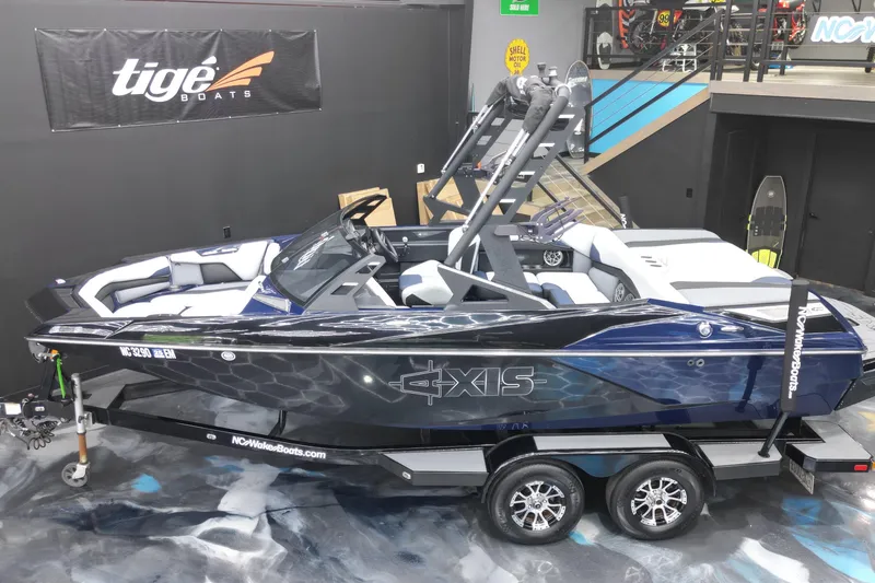 Slide: The Image of 2019 Axis A20 boat on trailer in showroom, featuring sleek design and modern interior. - 18