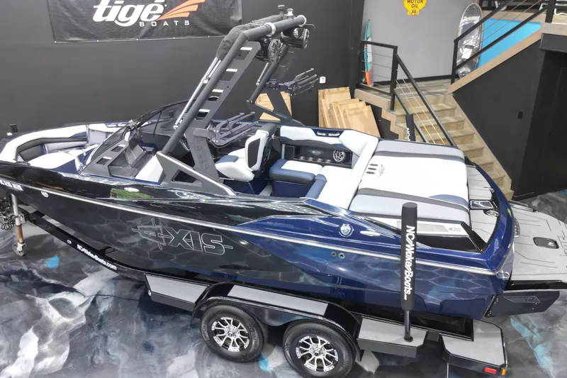 Slide: The Image of 2019 Axis A20 boat on trailer in showroom, featuring sleek design and modern interior. - 19