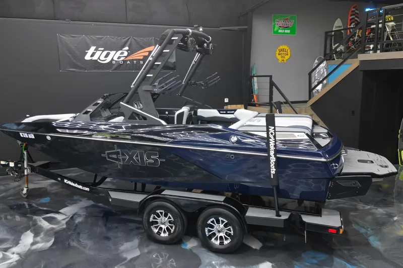 Slide: The Image of 2019 Axis A20 boat on trailer in showroom, featuring sleek design and modern features. - 3
