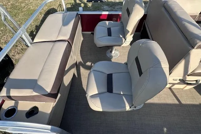 Slide: The Image of 2018 Sun Tracker SportFish 22 DLX interior with beige seating and cup holders. - 13