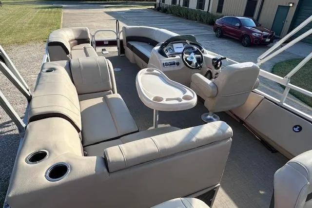 Slide: The Image of 2018 Sun Tracker SportFish 22 DLX pontoon boat interior with beige seating and steering console. - 15