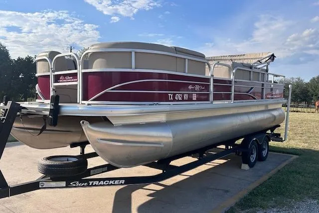 Slide: The Image of 2018 Sun Tracker SportFish 22 DLX pontoon boat on trailer, parked outdoors. - 6