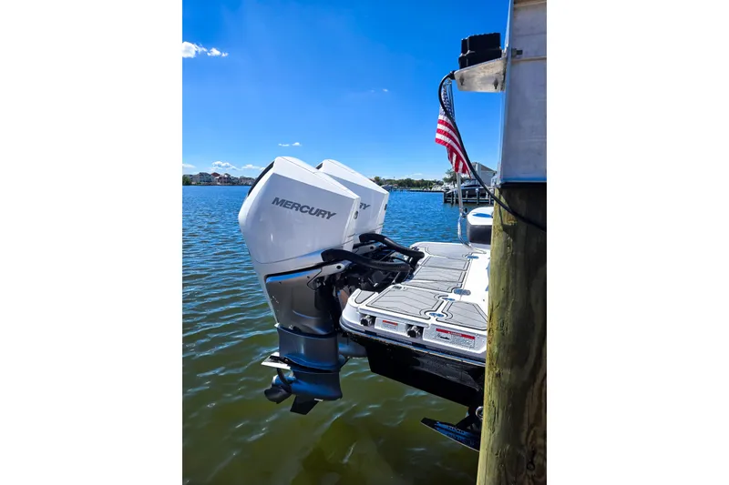 Slide: The Image of 2024 Monterey 305SS Super Sport boat with Mercury outboard engine docked by water. - 2