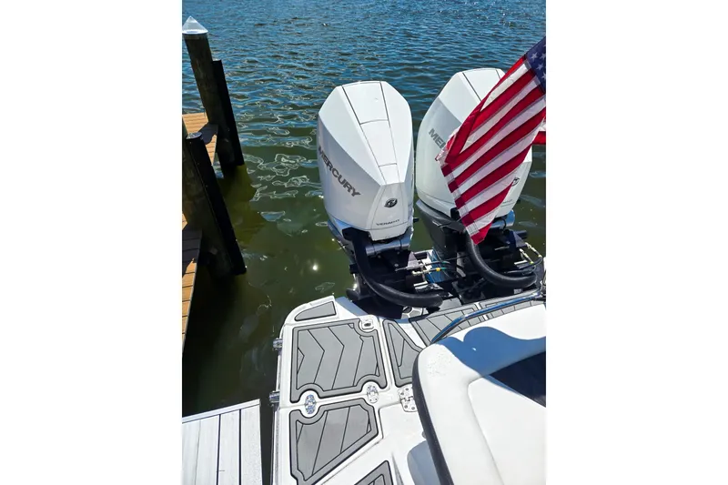 Slide: The Image of 2024 Monterey 305SS Super Sport boat with dual Mercury engines and American flag on water. - 3