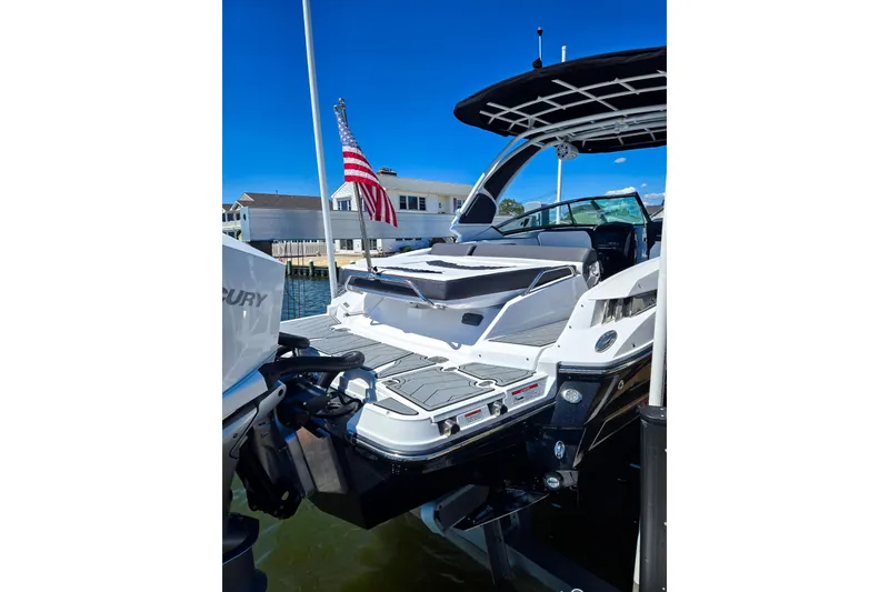 Slide: The Image of 2024 Monterey 305SS Super Sport boat docked, featuring sleek design and American flag. - 4