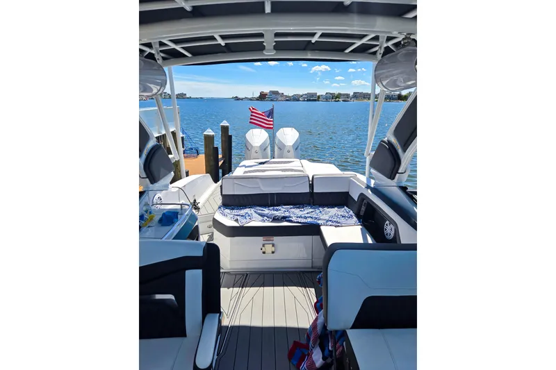 Slide: The Image of 2024 Monterey 305SS Super Sport boat interior with lake view and American flag. - 5