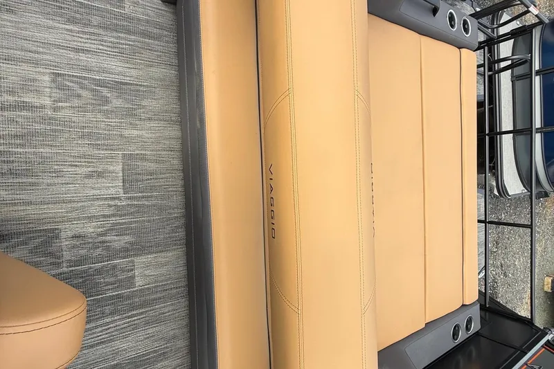 Slide: The Image of 2026 Viaggio Lago Z22S-CC boat seat with tan upholstery and cup holders. - 13