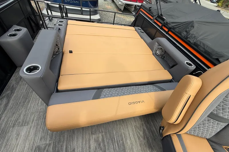 Slide: The Image of Luxurious seating on 2026 Viaggio Lago Z22S-CC boat with tan and gray upholstery. - 17
