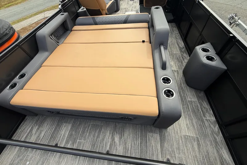 Slide: The Image of 2026 Viaggio Lago Z22S-CC boat interior with tan seating and cup holders. - 18