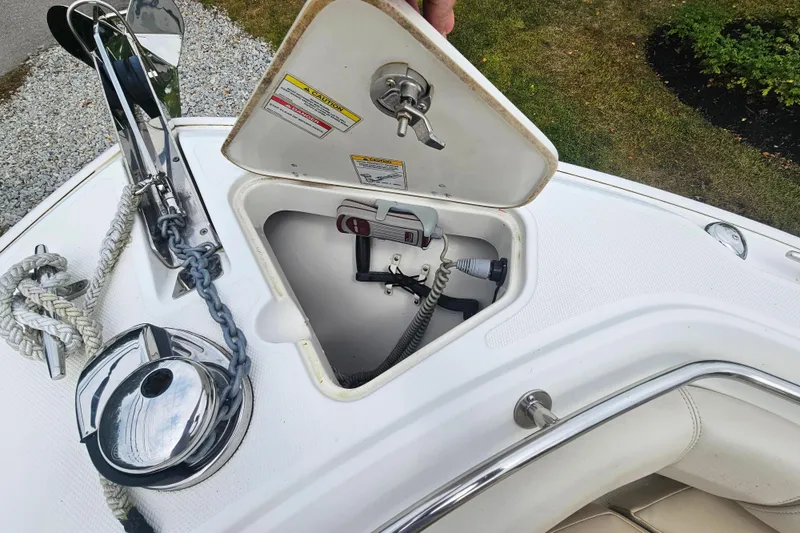 Slide: The Image of 2019 Boston Whaler 230 Outrage anchor compartment with rope and winch. - 12