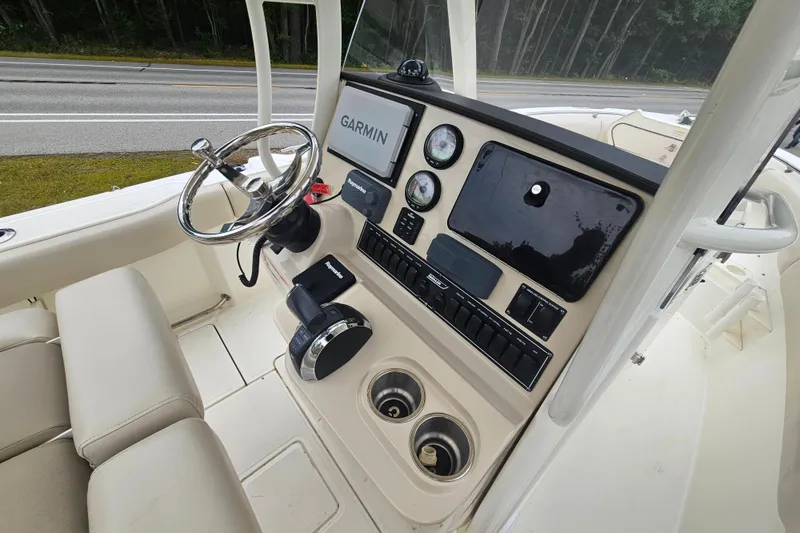 Slide: The Image of 2019 Boston Whaler 230 Outrage boat dashboard with Garmin navigation system and controls. - 18