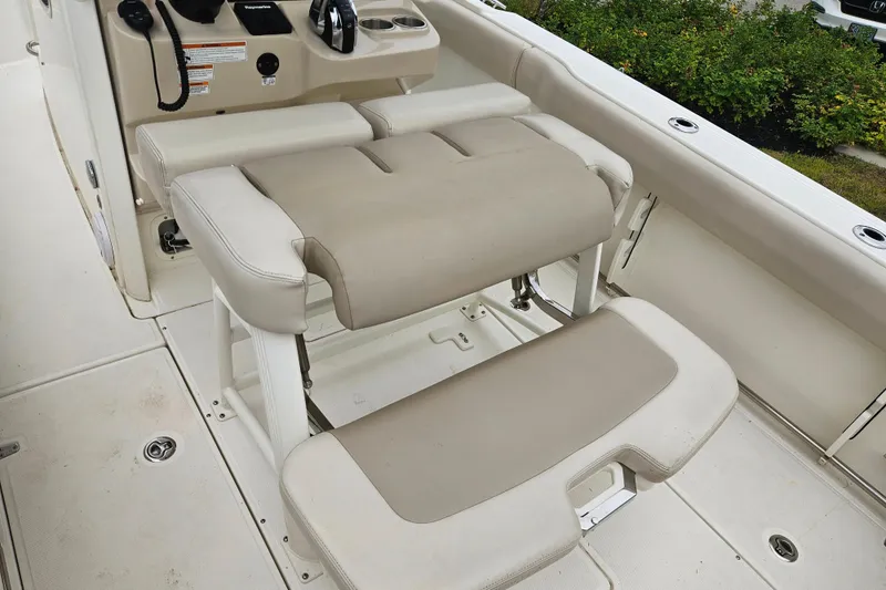 Slide: The Image of 2019 Boston Whaler 230 Outrage boat interior with beige seating and control panel. - 20