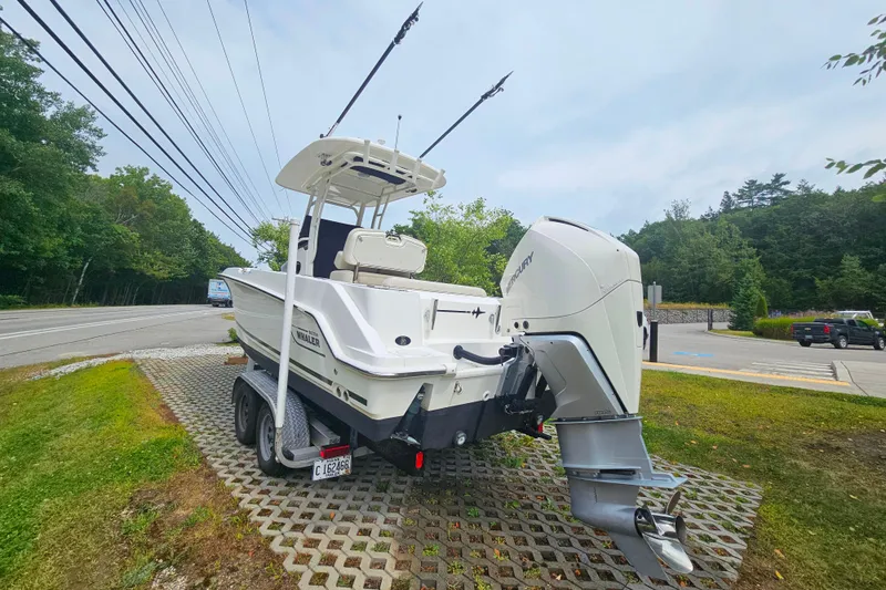 Slide: The Image of 2019 Boston Whaler 230 Outrage boat on trailer, parked near a road. - 3