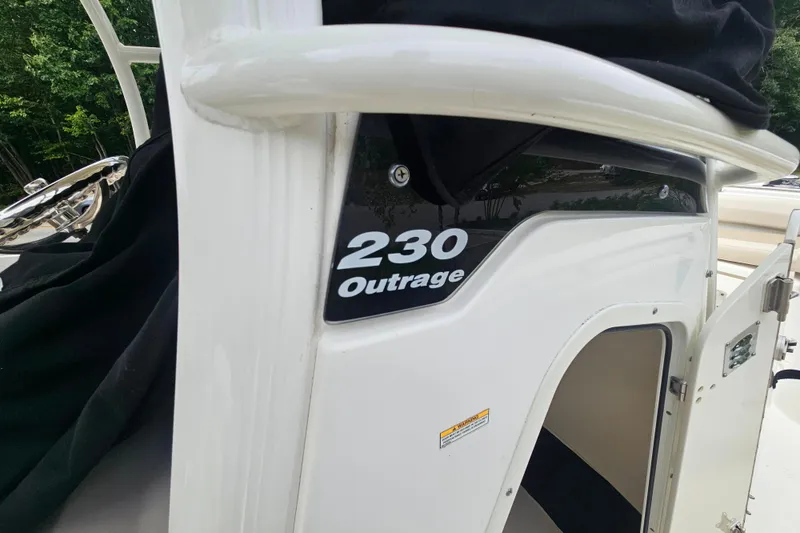 Slide: The Image of 2019 Boston Whaler 230 Outrage boat, close-up of model name on side panel. - 5