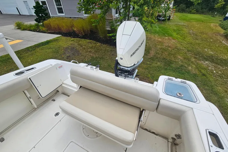 Slide: The Image of 2019 Boston Whaler 230 Outrage boat with Mercury engine, featuring comfortable seating and spacious deck. - 6
