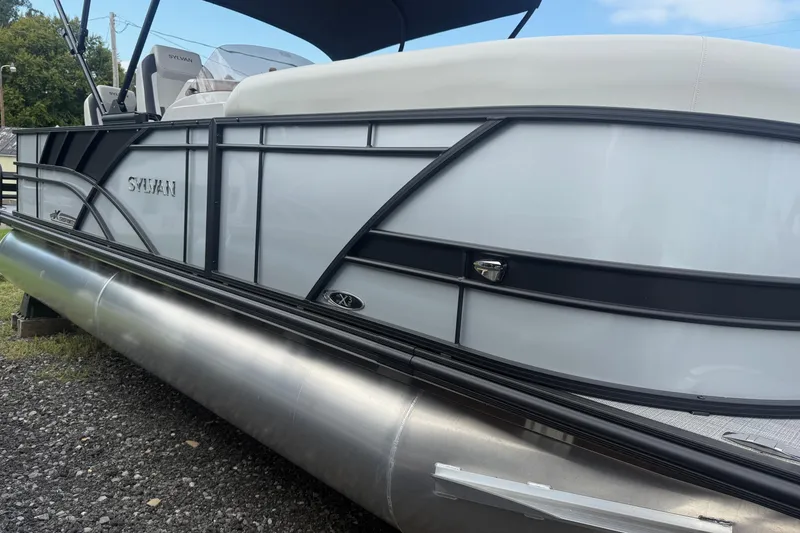 Slide: The Image of 2026 SLYVAN X-3 Party Fish pontoon boat, sleek design, side view. - 1