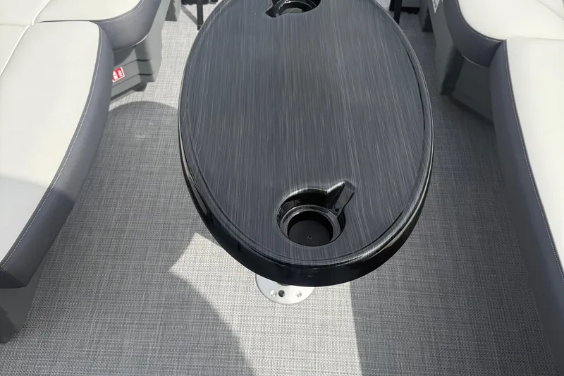 Slide: The Image of 2026 SLYVAN X-3 Party Fish boat interior with sleek table and cushioned seating. - 11