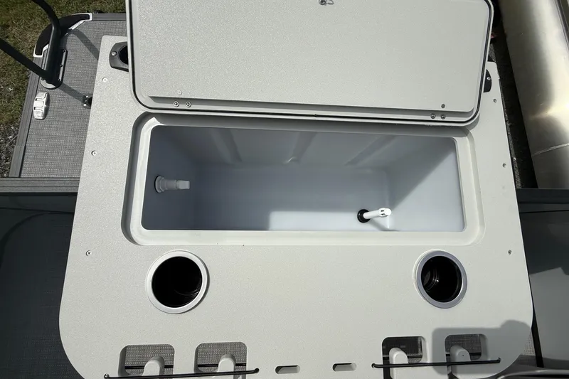 Slide: The Image of Open storage compartment on 2026 SLYVAN X-3 Party Fish boat with cup holders. - 18