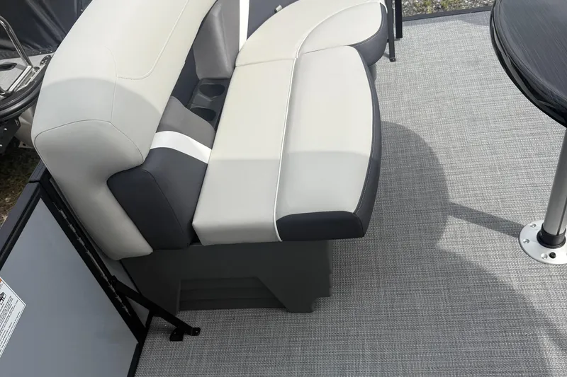 Slide: The Image of 2026 SLYVAN X-3 Party Fish boat interior with cushioned seating and table. - 9