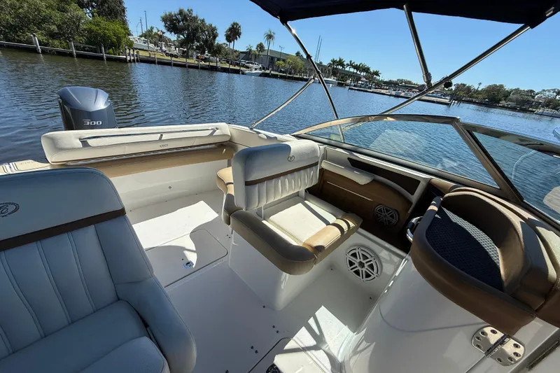 Slide: The Image of 2018 Cobalt 23SC boat interior with seating, steering, and water view. - 9