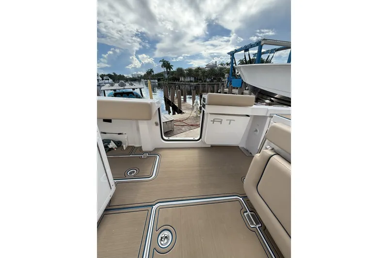 Slide: The Image of 2024 Southport 30 FE boat interior with tan seating and open deck view. - 12