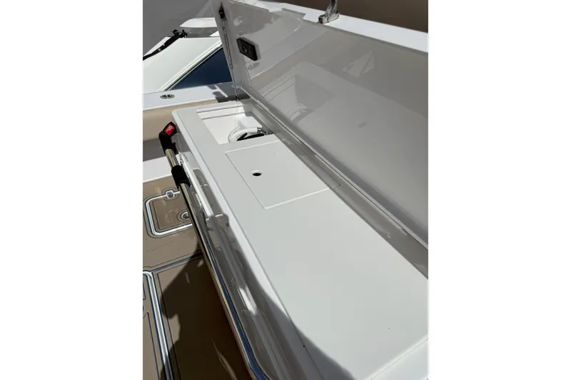 Slide: The Image of 2024 Southport 30 FE boat storage compartment with open lid, showcasing interior features. - 17