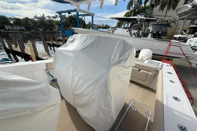 Slide: The Image of 2024 Southport 30 FE boat interior with covered equipment at a marina. - 19