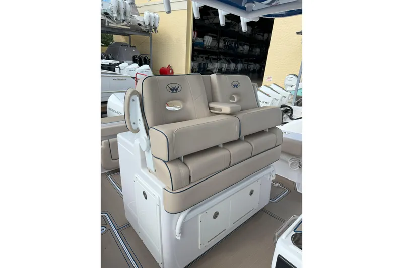 Slide: The Image of 2024 Southport 30 FE boat seating with beige cushions and storage compartments. - 20