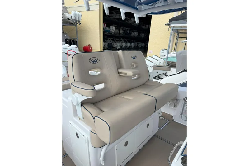 Slide: The Image of 2024 Southport 30 FE boat seating with beige upholstery and armrests. - 21