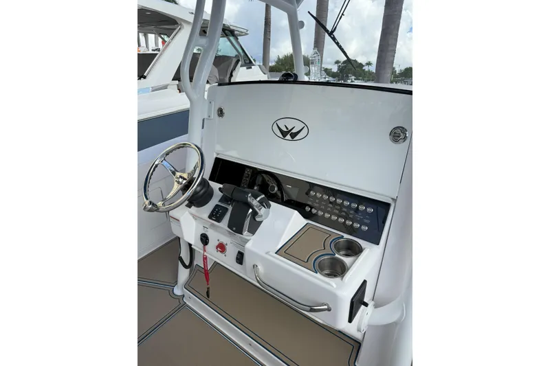 Slide: The Image of 2024 Southport 30 FE boat helm with steering wheel and control panel. - 23