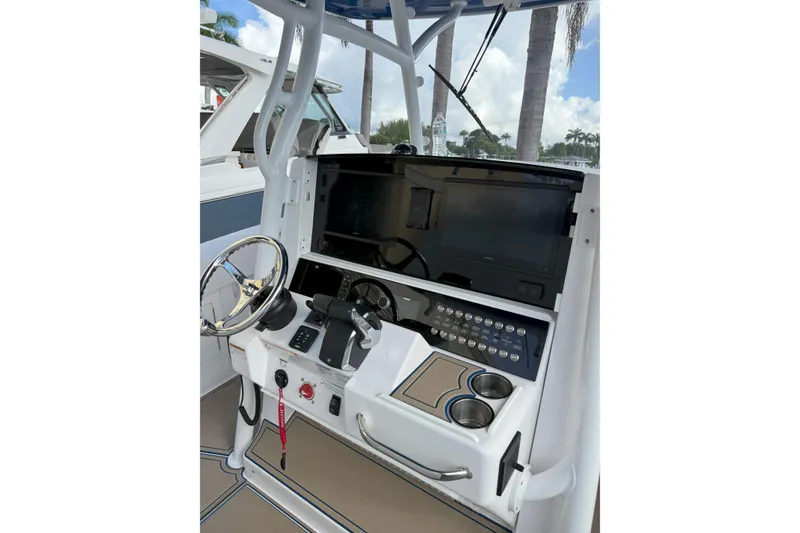 Slide: The Image of 2024 Southport 30 FE boat helm with steering wheel and control panel. - 24