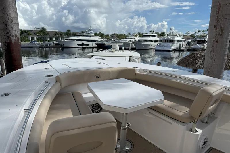 Slide: The Image of 2024 Southport 30 FE boat interior with seating and table, docked at a marina. - 29