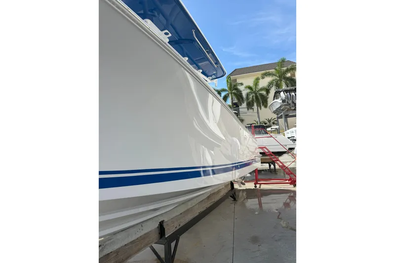 Slide: The Image of 2024 Southport 30 FE boat with sleek white hull and blue accents. - 3
