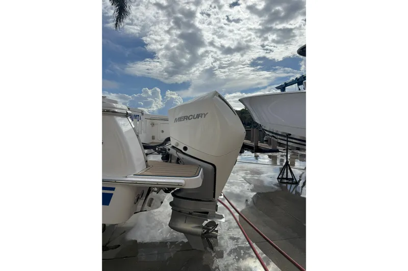 Slide: The Image of 2024 Southport 30 FE boat with Mercury outboard engine under a cloudy sky. - 6