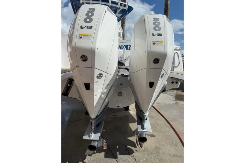 Slide: The Image of 2024 Southport 30 FE boat with dual 300 V8 engines, docked under a clear sky. - 7