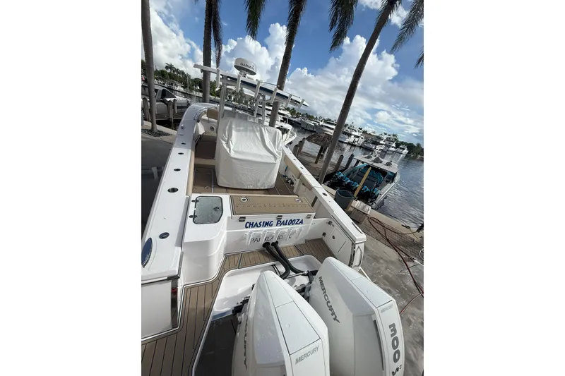 Slide: The Image of 2024 Southport 30 FE boat docked, featuring twin Mercury engines and a spacious deck. - 8