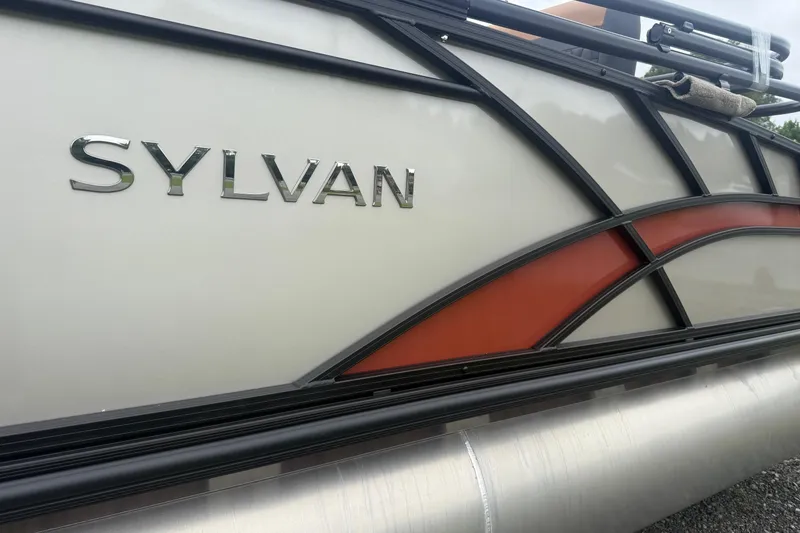 Slide: The Image of 2026 Sylvan L-3 DLZ DH boat side view with logo and design details. - 3