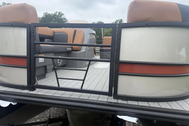 Slide: The Image of 2026 Sylvan L-3 DLZ DH pontoon boat with tan seating and sleek design. - 6