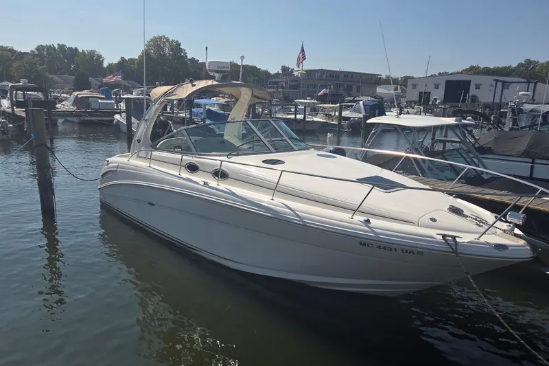 The Image of 2003 Sea Ray 300 Sundancer docked at marina, surrounded by other boats. - 0