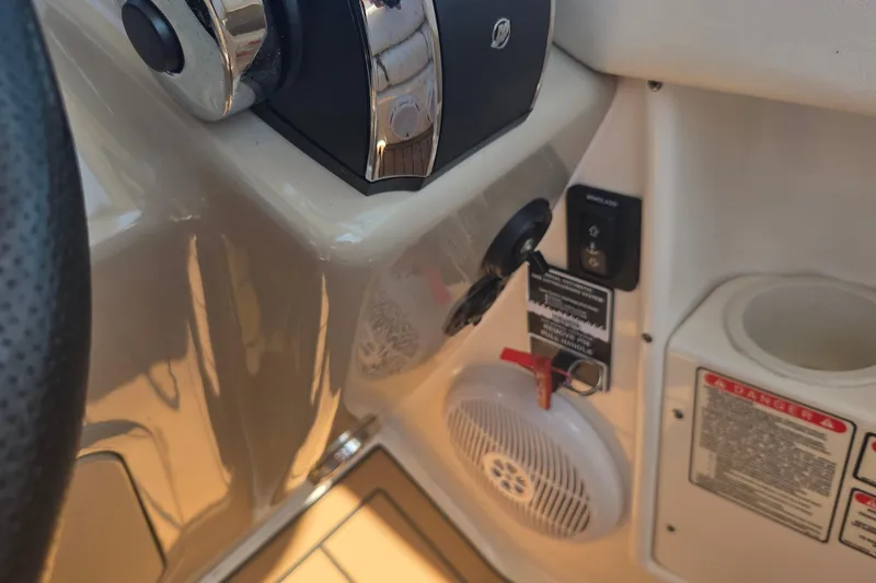 Slide: The Image of Control panel of a 2003 Sea Ray 300 Sundancer boat with ignition and warning labels. - 14