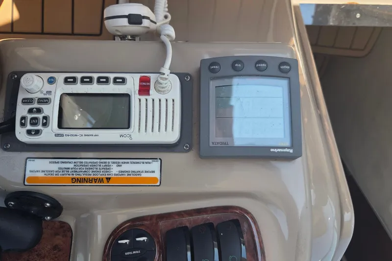 Slide: The Image of Control panel of a 2003 Sea Ray 300 Sundancer boat with navigation equipment. - 15